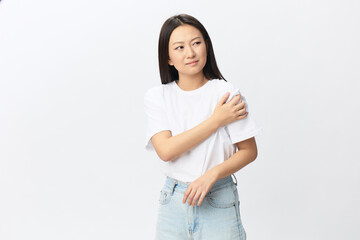 Suffering from neuralgia after sleeping in the wrong position tanned beautiful young Asian woman...