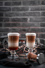 Presentation of bean coffee varieties with different types of cups on a special ground