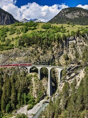 Railway bridge in Switzerland. Landwasser Viaduct in Graubunden near Davos Klosters Filisur. Railway company emblem.
