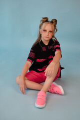 fashion teenager portrait. tween school girl with orange makeup wearing pink stylish cool clothes...