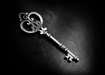 Old bronze key on a dark background