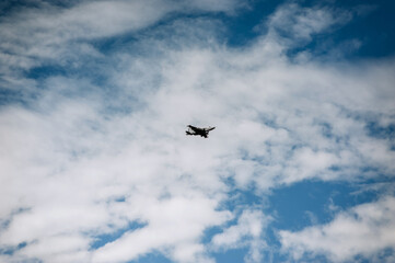 A large military fighter jet flies in the sky.