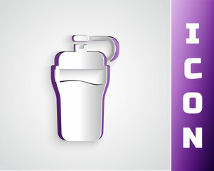 Paper cut Fitness shaker icon isolated on grey background. Sports shaker bottle with lid for water and protein cocktails. Paper art style. Vector