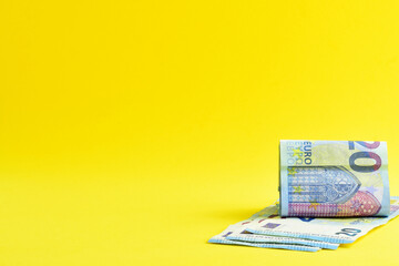 Twenty euro banknotes on yellow background. Copy space.