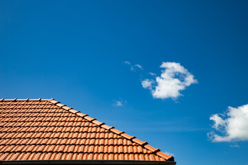 new red tiles roof and blue sky - obrazy, fototapety, plakaty