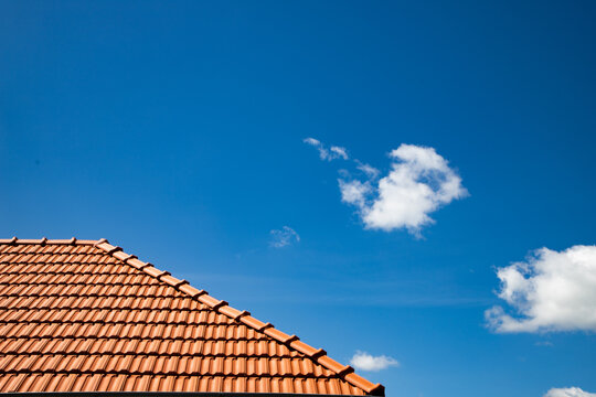 New Red Tiles Roof And Blue Sky