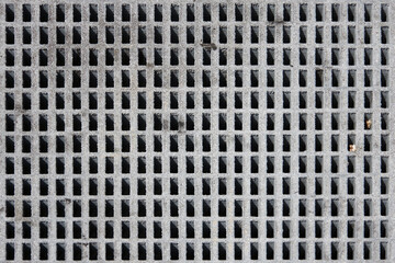 Full frame view of a concrete grid manhole cover plate