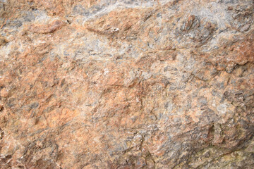 Background of a rocky surface in shades of brown and gray. Nature texture