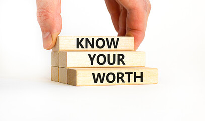 Know your worth symbol. Concept words Know your worth on wooden blocks. Businessman hand. Beautiful white table white background. Business and know your worth concept. Copy space.