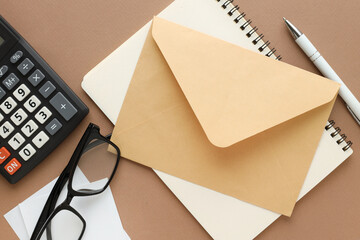 Brown envelope standard size. working environment.calculator and glasses