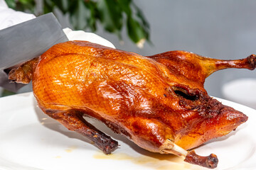 Chinese cook prepares beijing Roast Duck. Peking Duck is a famous duck dish from Beijing that has been prepared since the imperial era, and is now considered one of China's national foods