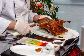 Chinese cook prepares beijing Roast Duck. Peking Duck is a famous duck dish from Beijing that has...