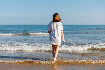 Portrait of a teenage girl on the beach, summer holidays by the sea