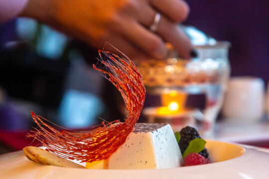 Italian dessert - Panakota with soft liquid caramel and a cup of fresh coffee. Panna Cotta, caramel, wild berries, red currant lat. R bes r brum , mint. Milk dessert for breakfast. Selective focus