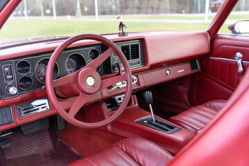 red steering wheel, dashboard of an old powerful classic American car