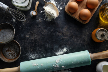 Baking concept with ingredients on dark