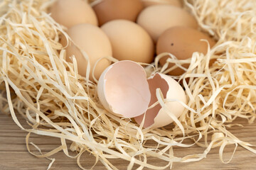 Chicken eggs in a nest of straw. Close up. Eggshell.