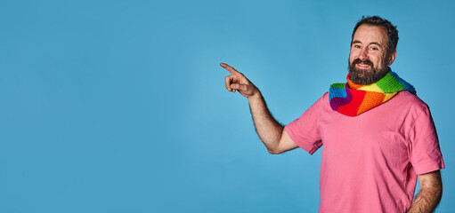 pride day. lgtb community. happy gay man, pointing to a large empty space for advertising. lgtb...