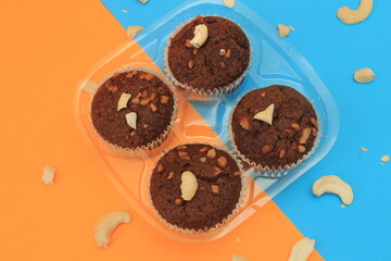 Chocolate muffin isolated on color background. Delicious chocolate muffin with nuts.