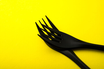Black on yellow. Black forks on a yellow background