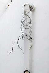 Coiled barb wire on a pipe