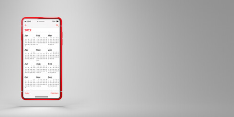 Red mobile phone with the application Calendar 2022 on a white background. Calendar app on smartphone screen and space for placing text. Business or time management concept