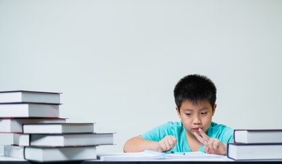 boy doing homework on white background, education concept
