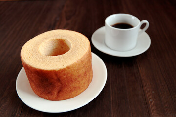 Eating Baumkuchen as a gift at a wedding ceremony at the table at tea time
