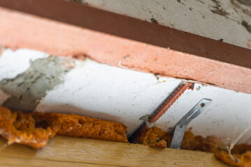 The window opening is reinforced with an iron corner and fittings