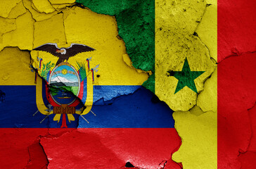 flags of Ecuador and Senegal painted on cracked wall