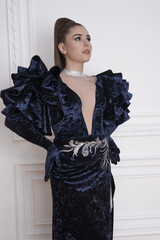 beautiful girl in an evening dress in the studio