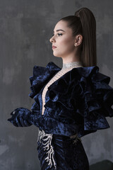 beautiful girl in an evening dress in the studio