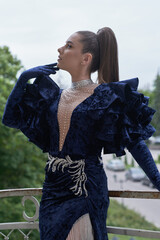 beautiful girl in evening dress on the summer veranda