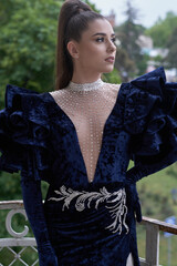 beautiful girl in evening dress on the summer veranda