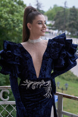 beautiful girl in evening dress on the summer veranda