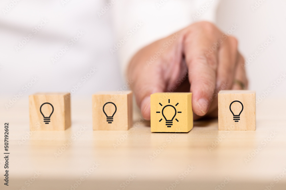 Poster hand pick wooden blocks with thinking and idea icon. Concept for creative and design solution.