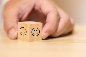wooden blocks with good and bad face graphic. Concept for rating and customer satisfaction.