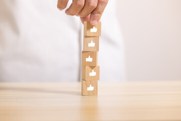 hand stack wooden blocks with thumb up icon . Concept for rating and customer satisfaction.