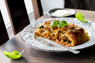 A serving of gourmet lasagna roll ups, ready for eating.
