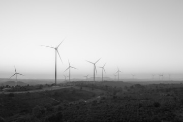 Wind turbines on beautiful sunny mountain and forest landscape. Green ecological power energy...