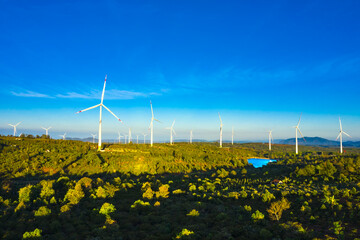Wind turbine towers farm in a big field to generate electricity. Clean alternative energy concept...