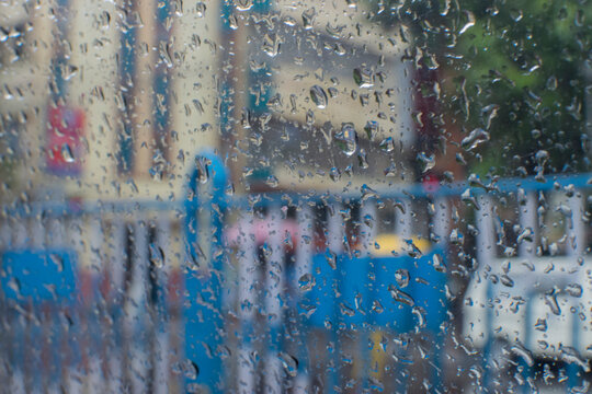 Raindrops falling on glass, abstract blurs - monsoon stock image of Kolkata (formerly Calcutta) city , West Bengal, India