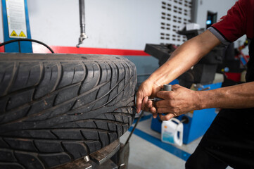 A set of workers remove the tire from the rim with a tire-removing machine device,Mechanic repairing tire