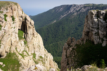 Panorama in a mountainous area in summer. Landscape with mountains, hills and cliffs. Front view.