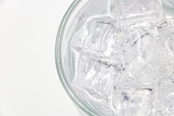 Soda sparkling water with Ice in glass over white background.