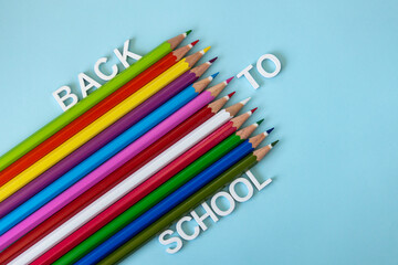 Colorful neon pencils on light blue background. Back to school concept