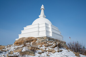 Buddhist stupa of enlightenment on island Ogoy lake Baikal Russia sunlight.