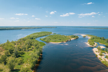 Aerial landscape view on Volga river with islands and green forest. Picturesque panoramic view from the height on the touristic part of the Volga river near Samara city at summer sunny day.