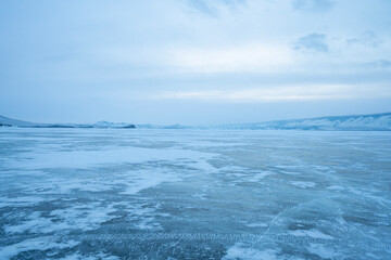 Baikal Lake. Unusual winter landscape. White layered bubbles in transparent ice