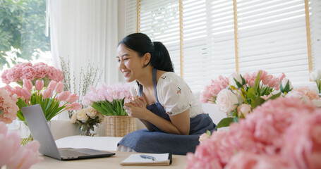 SME owner modern small flower shop work at home office happy smile fist up read text e-mail message...